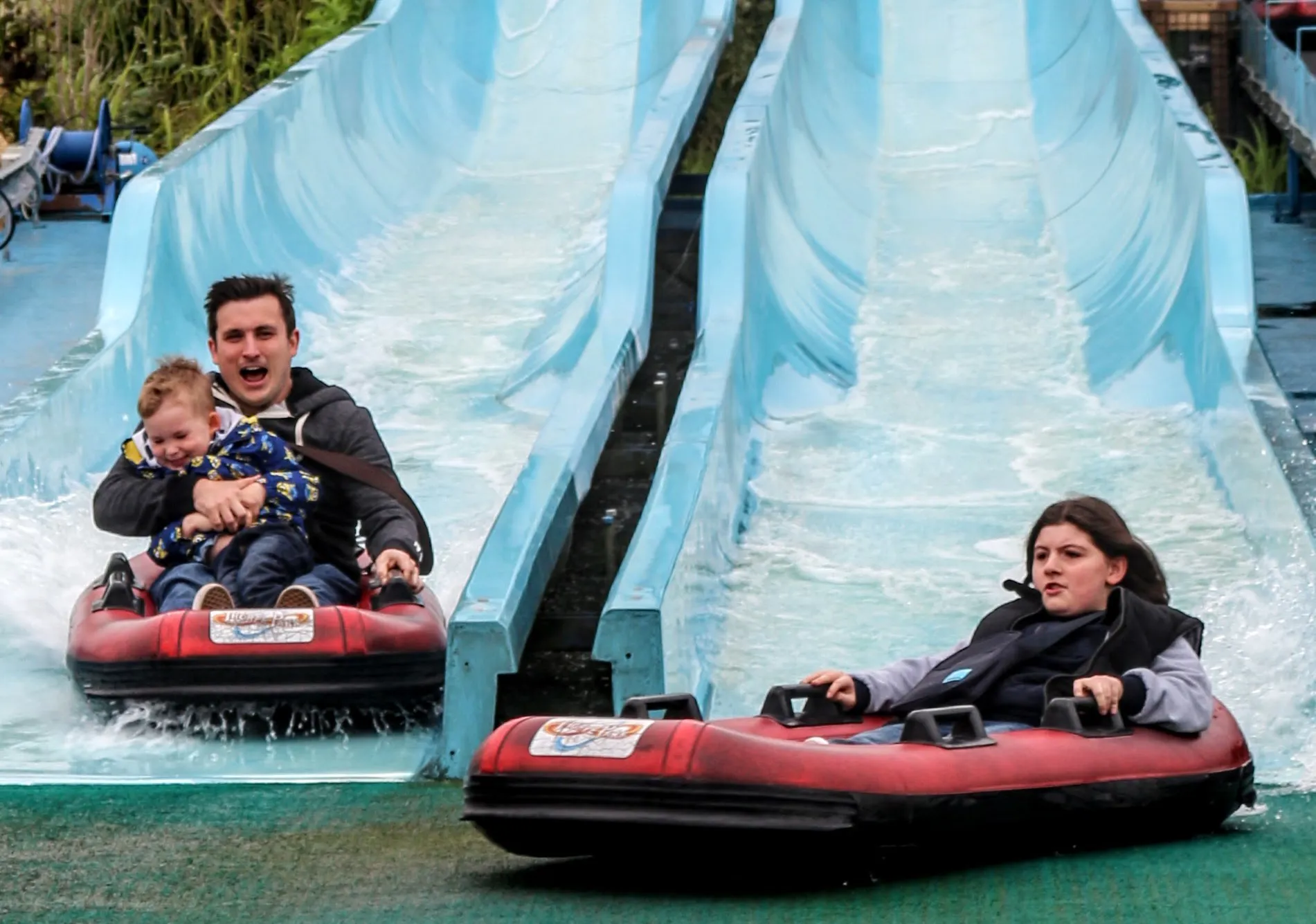 Kip Hakes and his family coming down the depth charge water slides